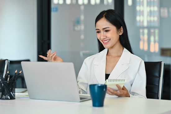 Happy female healthcare professional in conference call