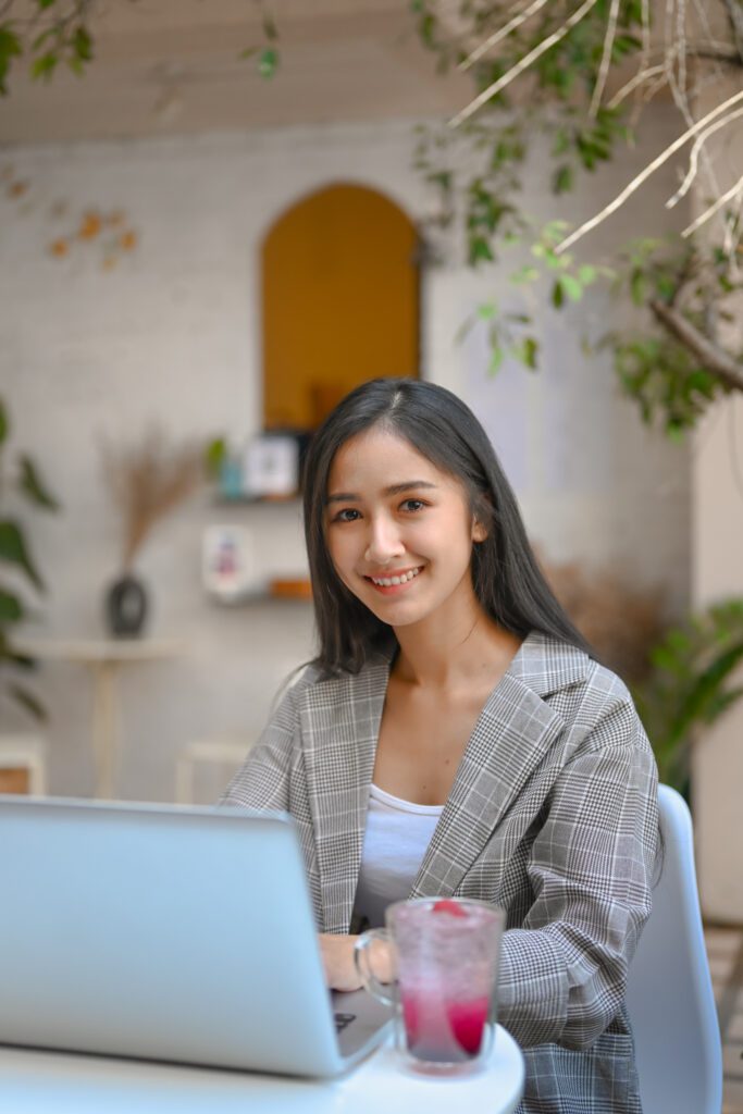 Portrait of confident businesswoman working with laptop computer